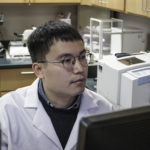 Picture of Qijun Zhang in a lab