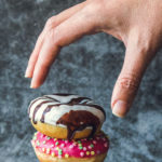 Picture of someone reaching for donut