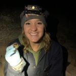 Graduate student Mallory Tate with a bat.