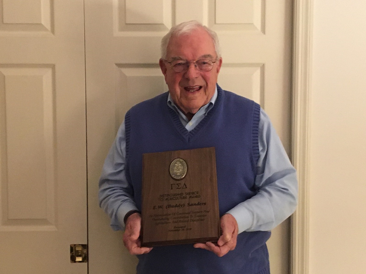 Picture of Buddy Sanders with his award