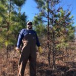 Bret Elgersma standing in an oak-pine plantation.