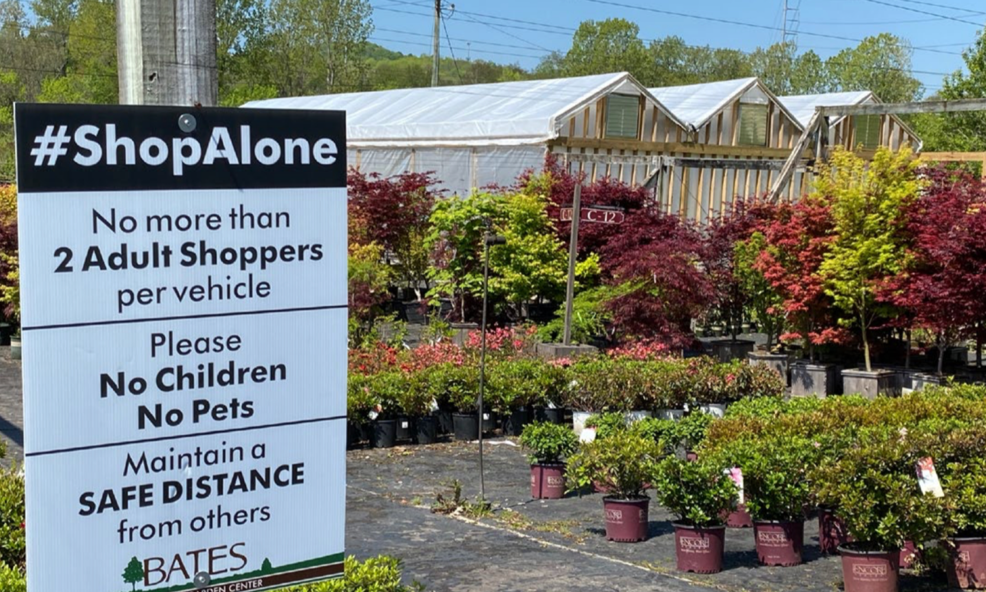 Signage in front of a garden center giving instructions on COVID-19 safety measures