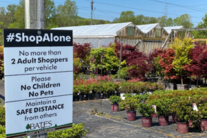 Signage in front of a garden center giving instructions on COVID-19 safety measures