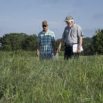 Johnny Richwine and Pat Keyser inspect a field of native grasses.