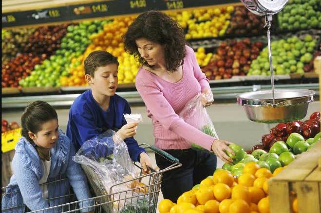 Photo of a family shopping in the produce section of a grocery store