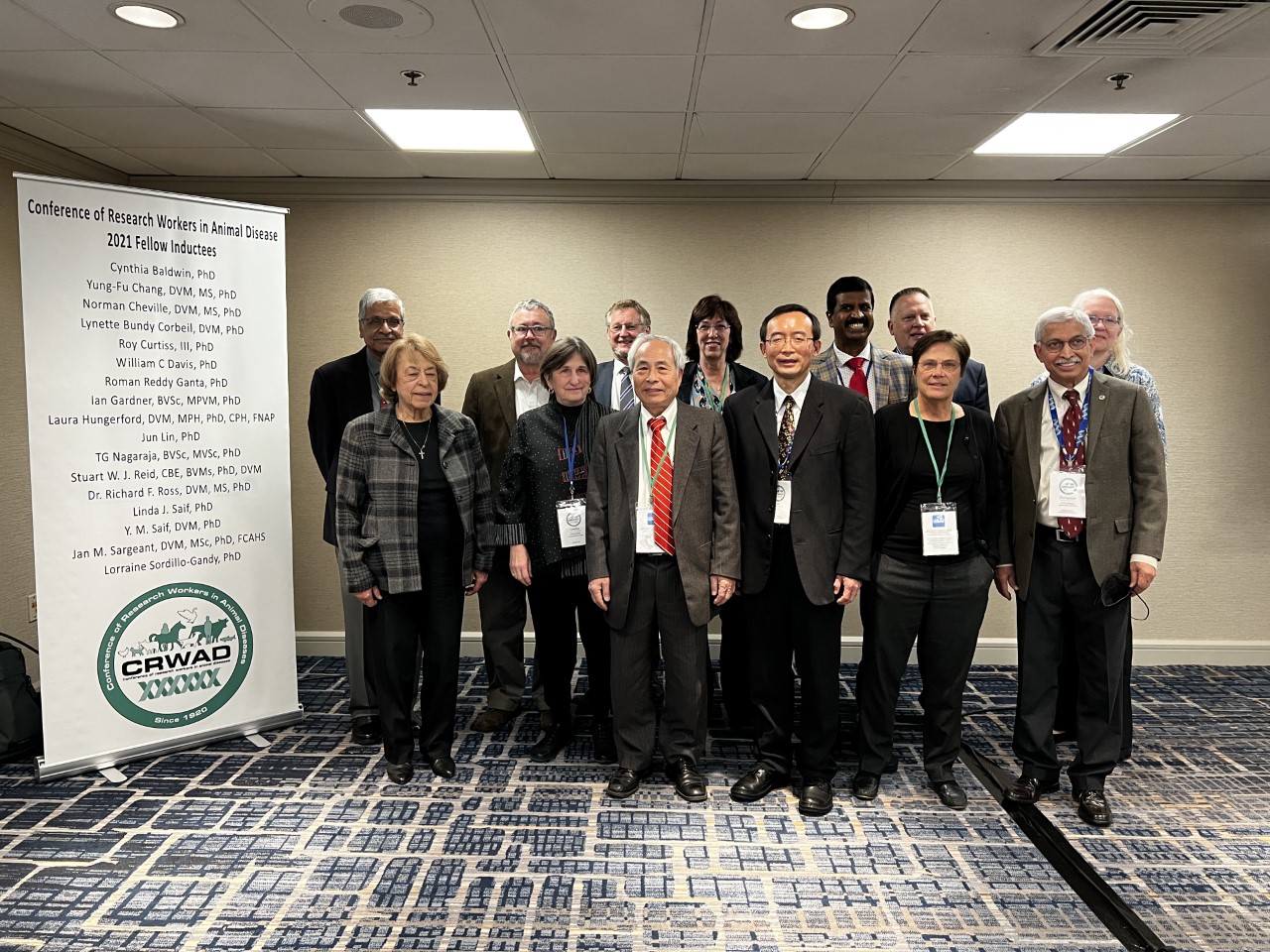 Jun Lin poses with the 15 other Fellow Inductees.