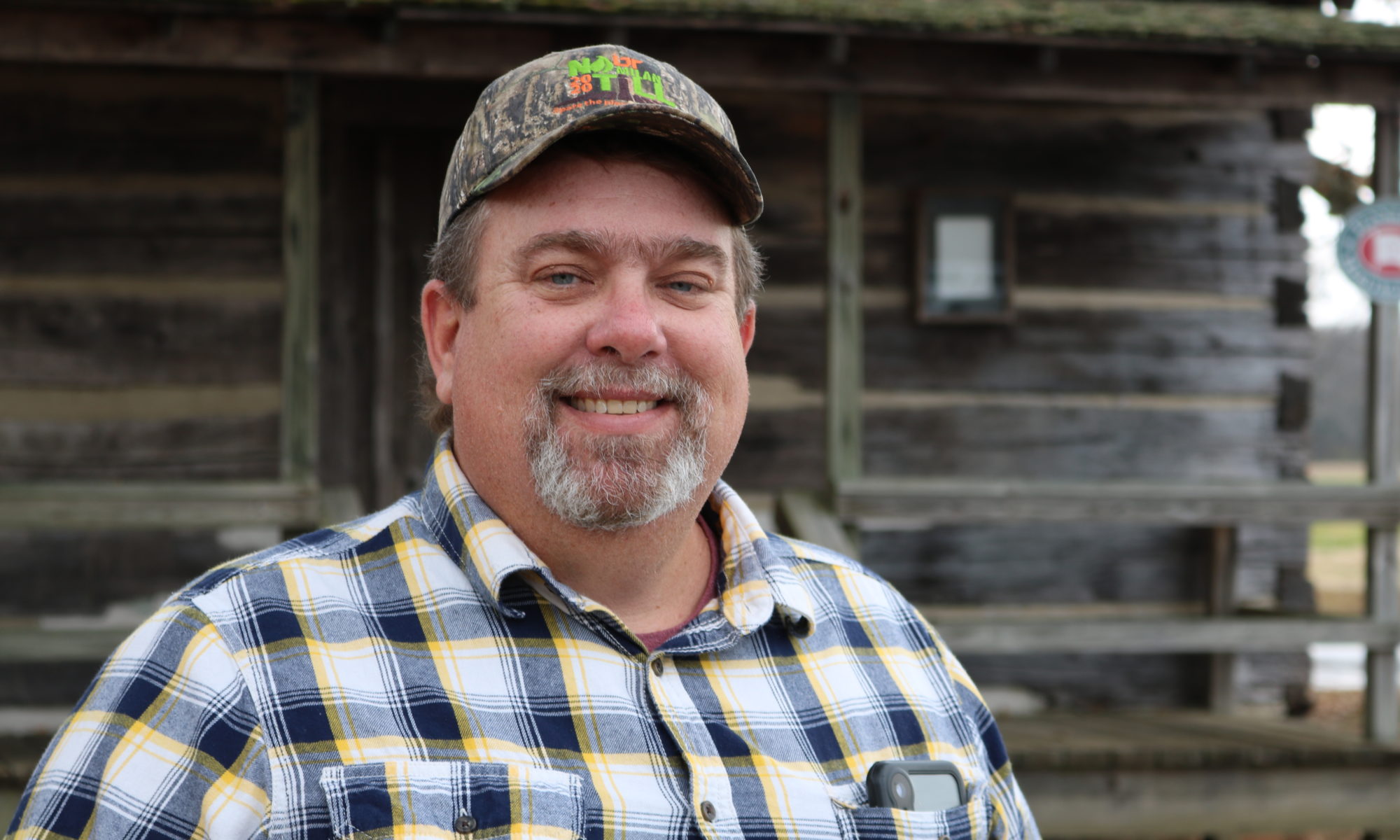 Jason Williams stands in front of cabin at Milan AgResearch and Education Center