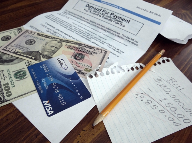 Picture of cash, credit card, and various papers where a family has planned for a budget