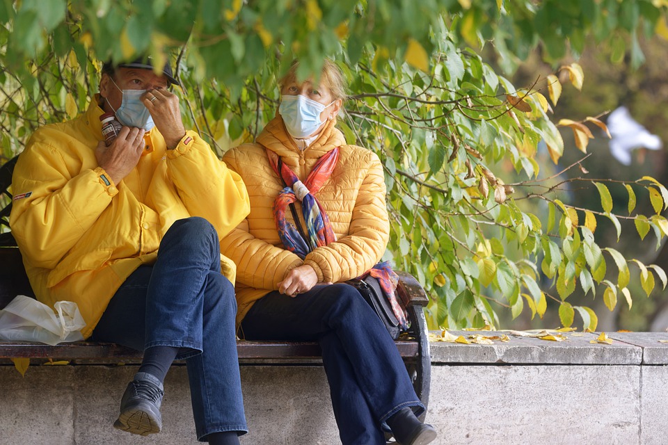 Two people wearing masks