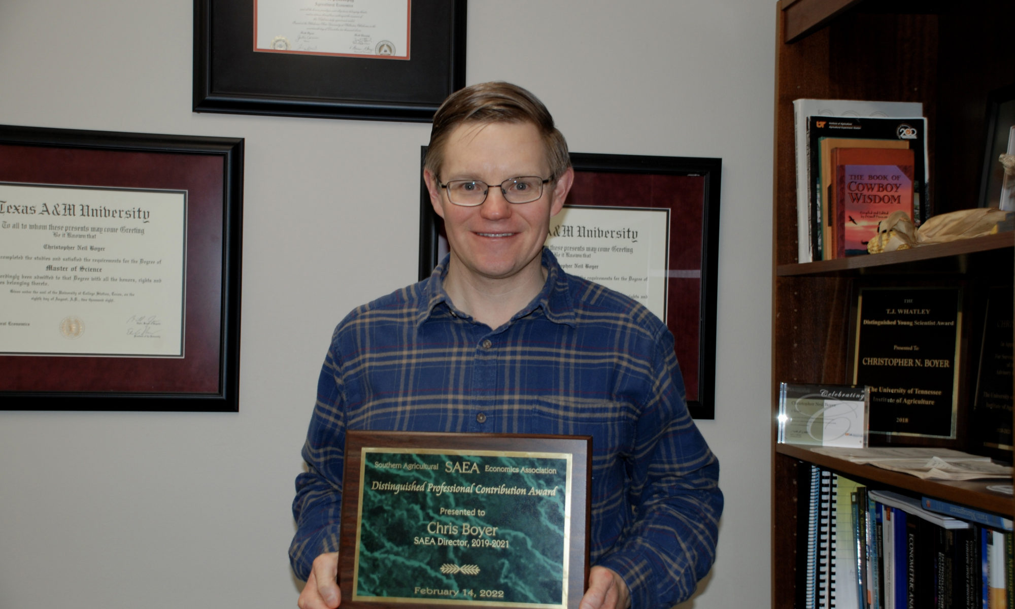 Chris Boyer holding an award