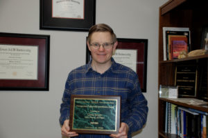 Chris Boyer holding an award
