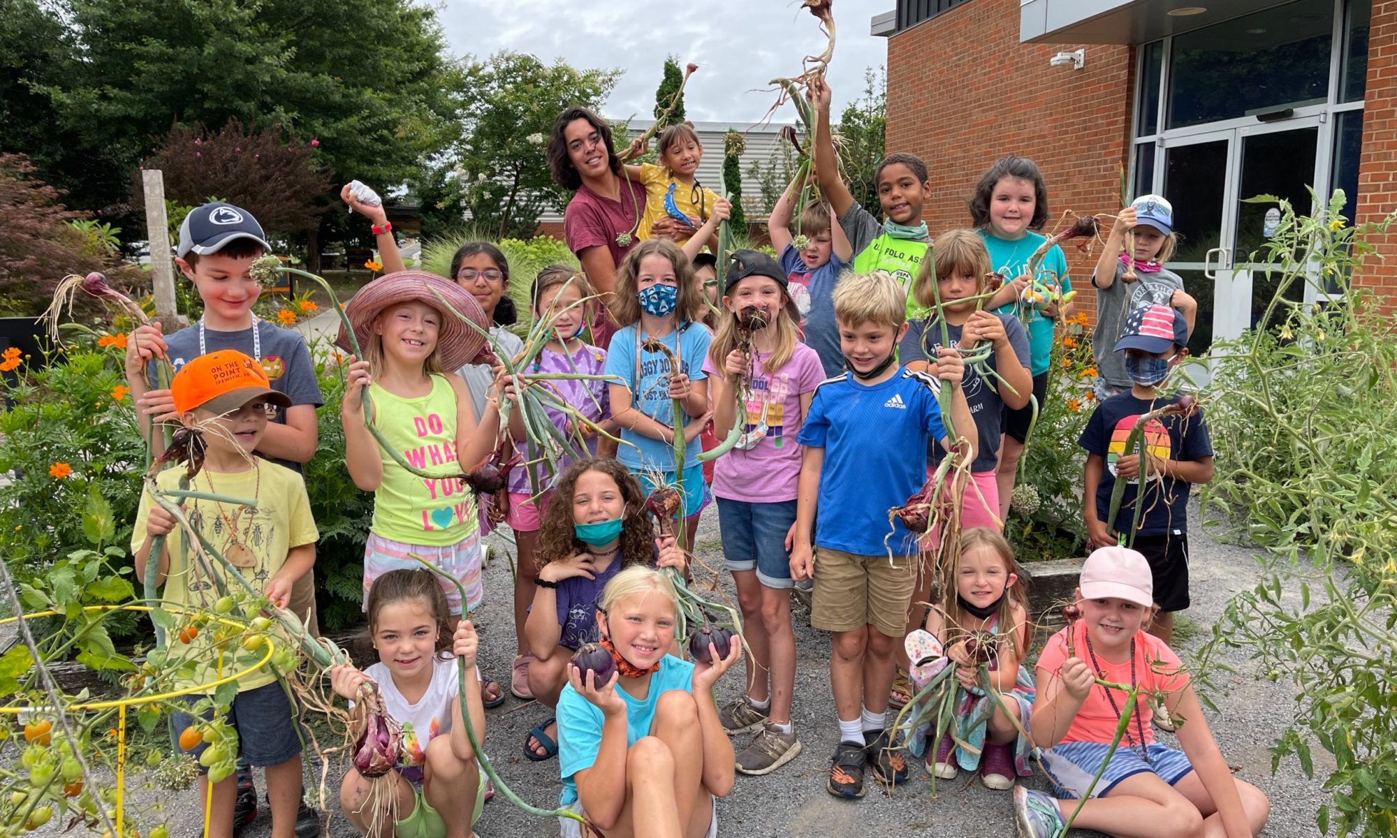 Youth campers holding crops