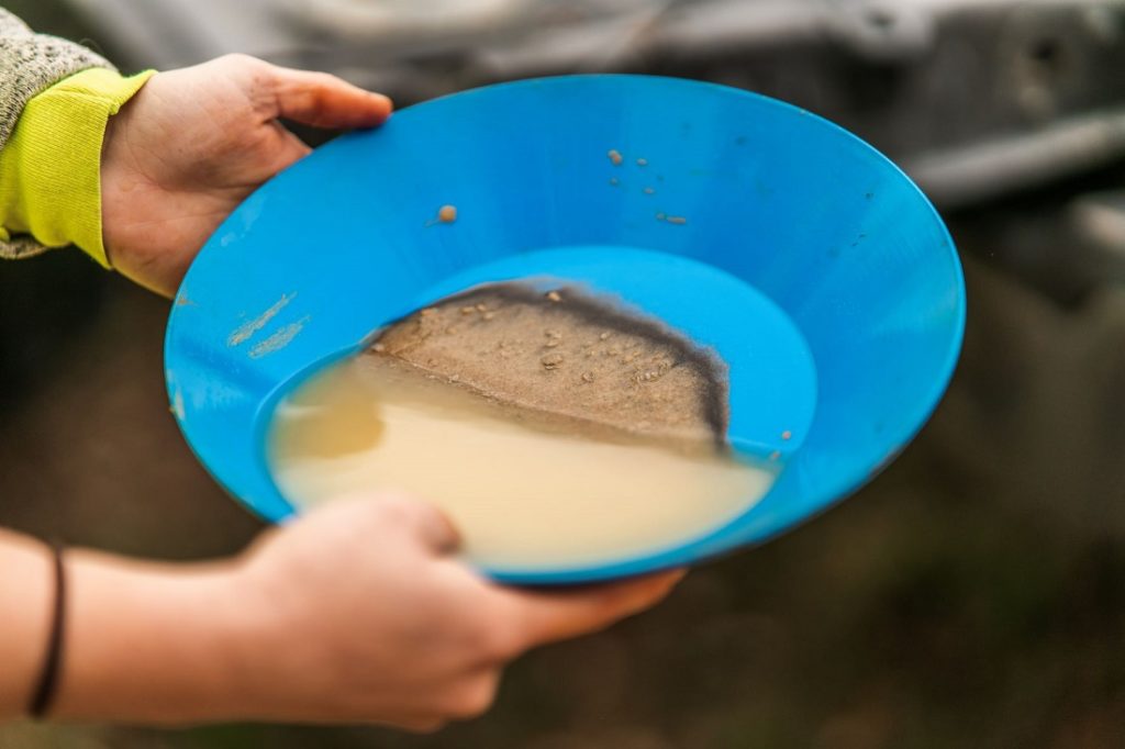 Soil being sifted in bowl