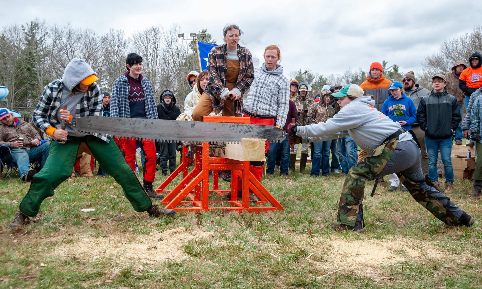 students sawing a log at the forestry conclave