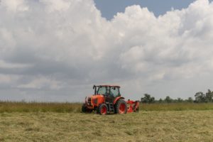 tractor harvesting in field