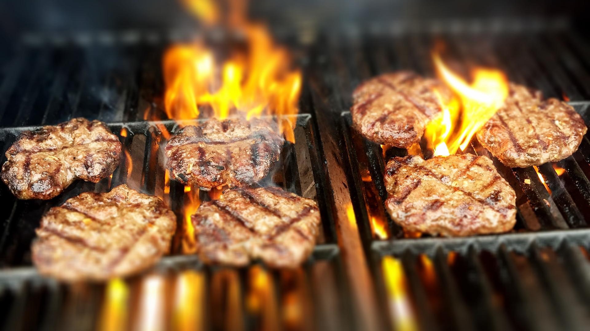 burgers on fiery grill
