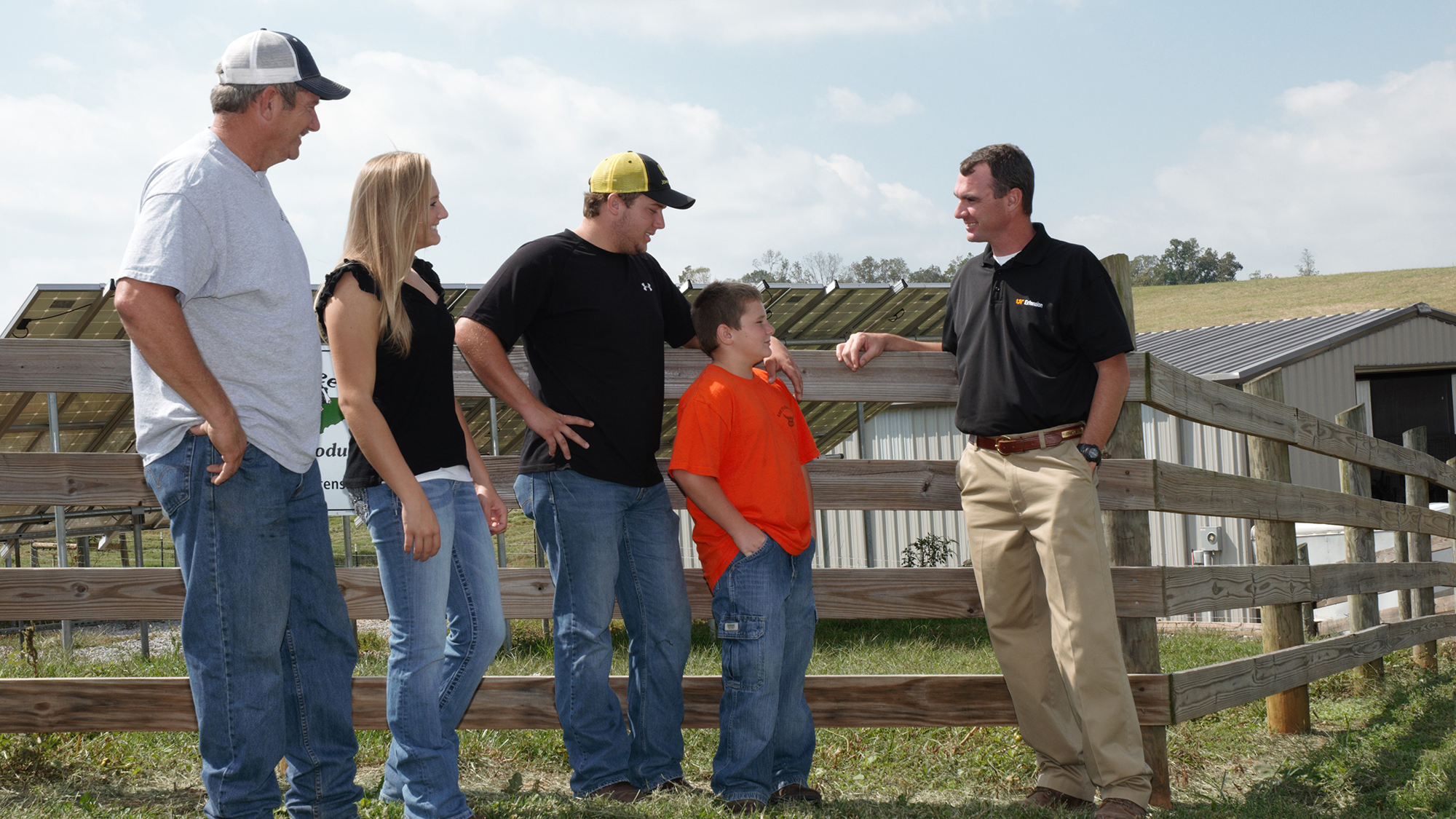 UT Extension agent talkign with family of four on farm