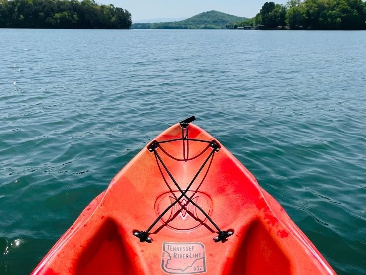 prow of red kayak floating on Tennessee