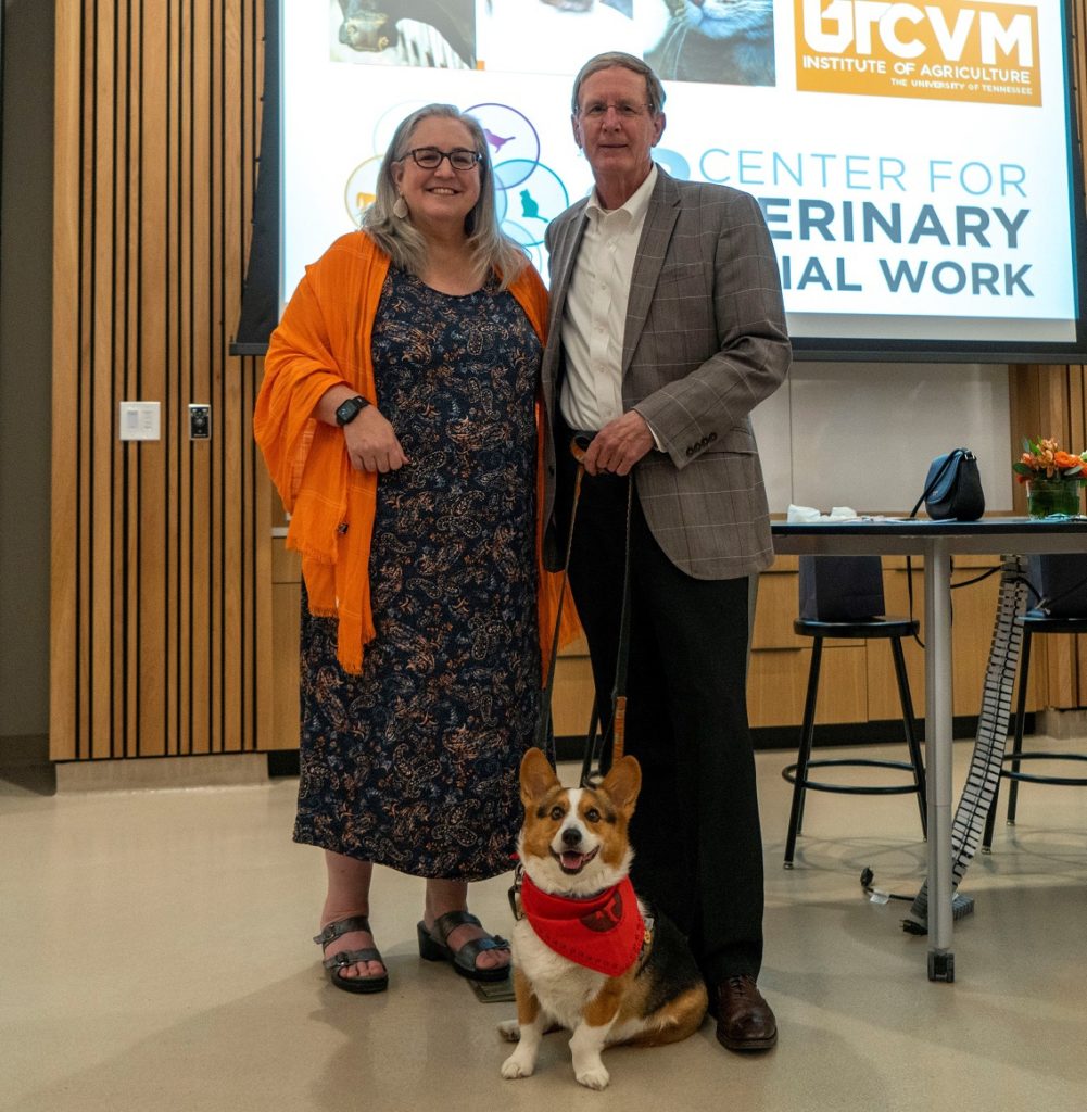 Lori Messinger poses with Jim Thompson and a dog