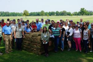 attendees gather in field at SFIREG meeting