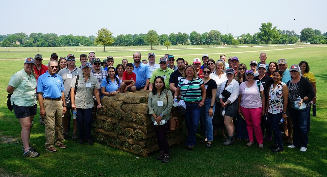 attendees gather in field at SFIREG meeting