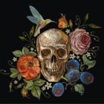 Embriodered skull surrounded by flowers and a hummingbird