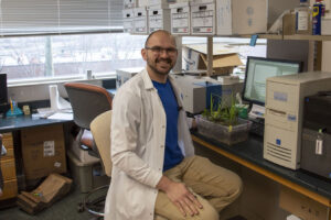 Rob Sears sits in front of his bioengineered potato plants in his lab in Knoxville, Tennessee.