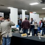 Agricultural producers and other attendees talk to vendors at the West Tennessee Grain and Soybean Producers Conference's annual trade show