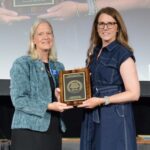 Dana Porter, professor with Texas A&M and president of ASABE (2023-2024), presenting an award to Lori Duncan