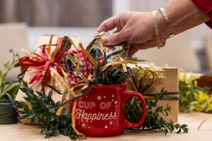 a hand putting together a homemade holiday gift