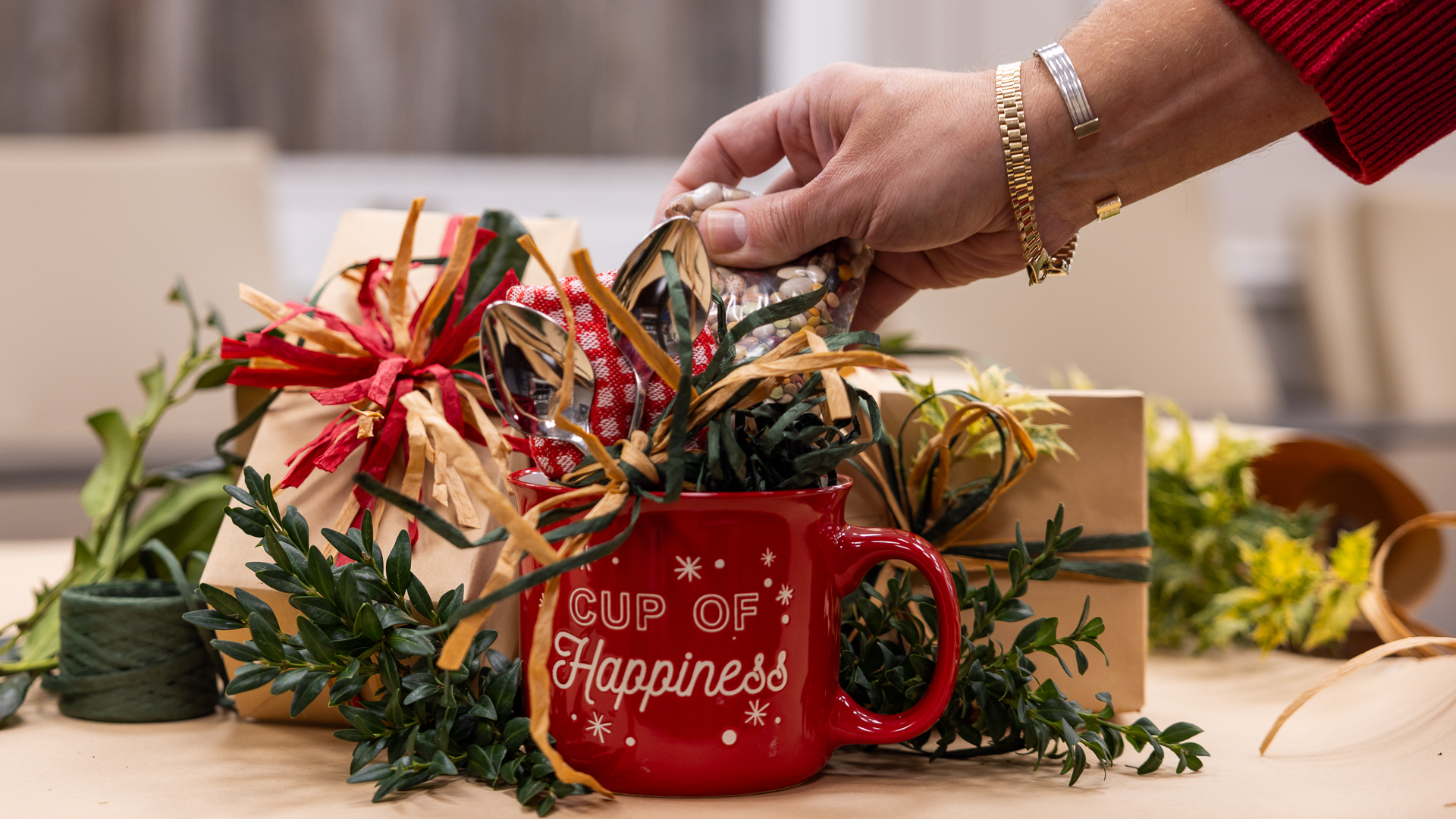 a hand putting together a homemade holiday gift