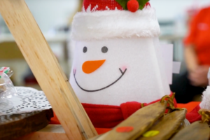 A felt snowman on a craft table