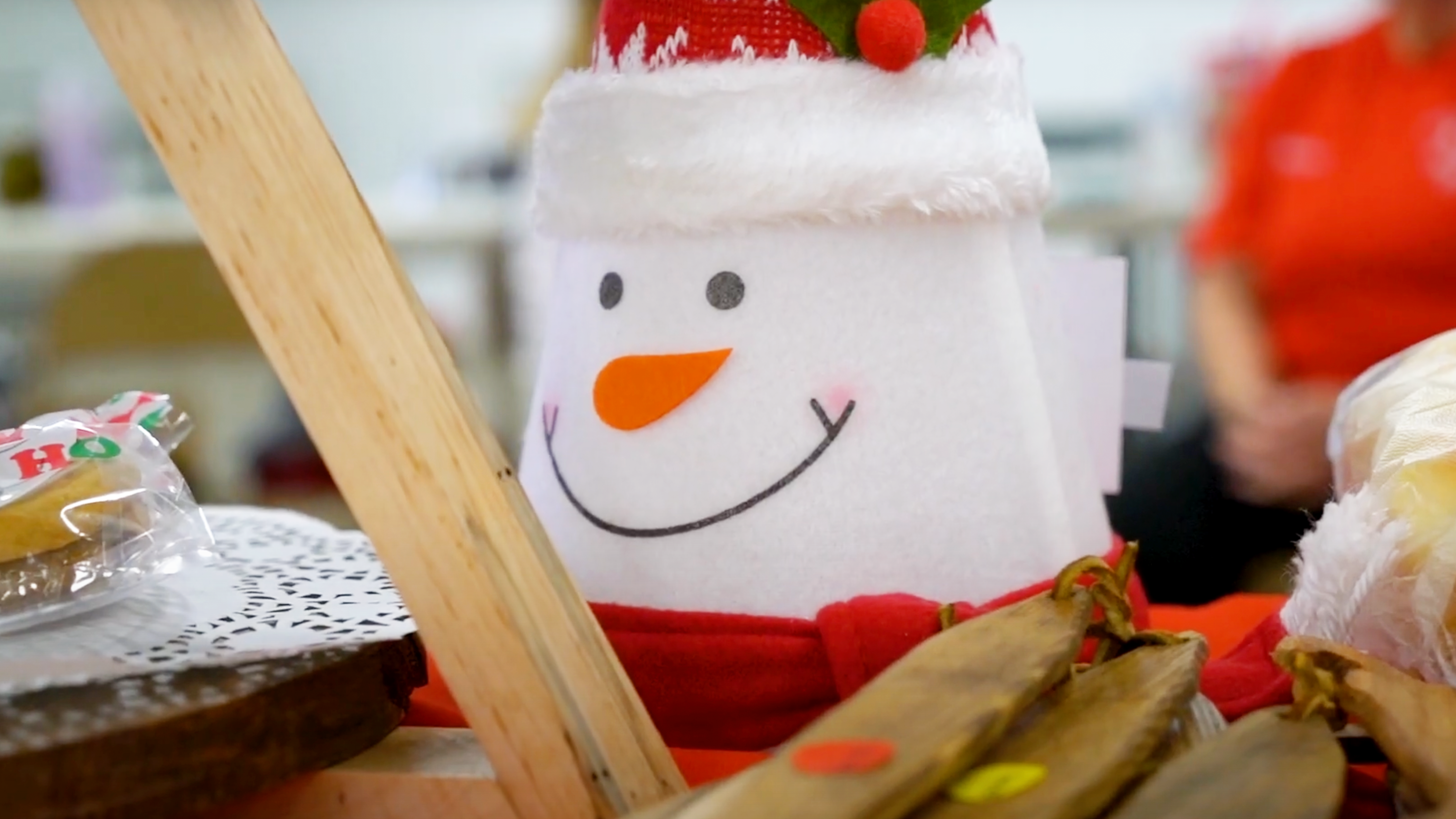 A felt snowman on a craft table