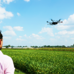 a man flying a drone over a field