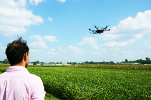 a man flying a drone over a field