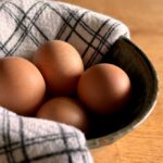 4 brown eggs in a bowl