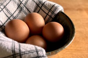 4 brown eggs in a bowl