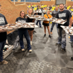 Participants of the UTIA Smoking School holding trays of meat