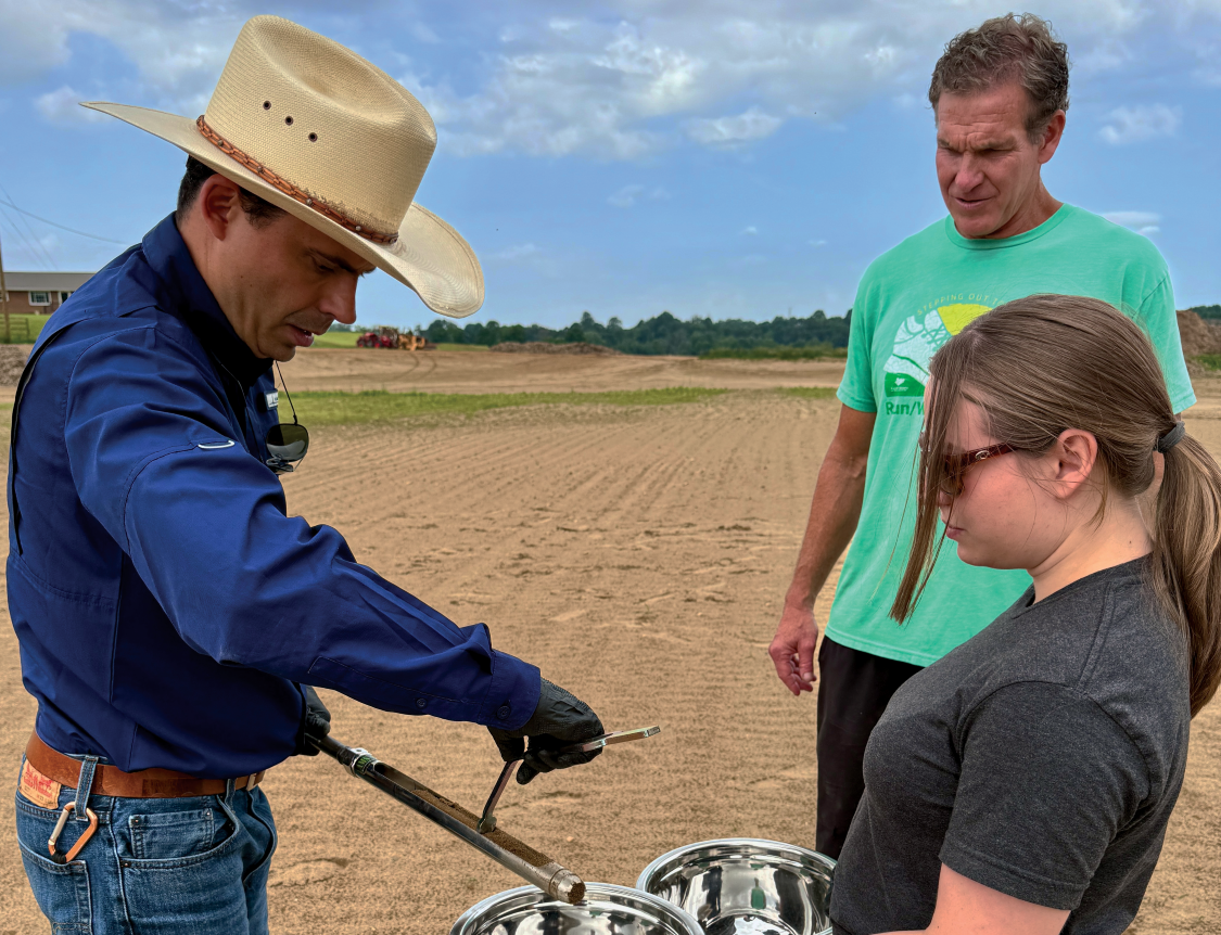 farmer Will Runion takes soil samples from one of his reclaimed flooded fields with Bruno Pedreira and Ali Bledsoe