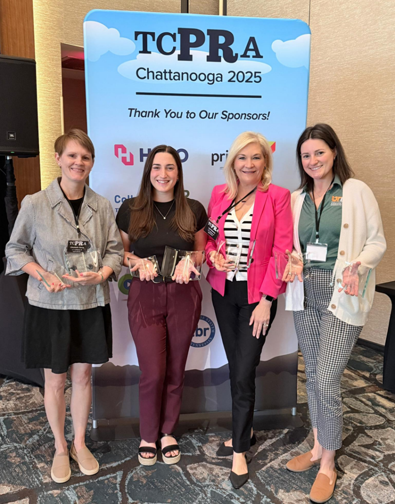 four members of the UTIA Office of Marketing and Communications holding their awards