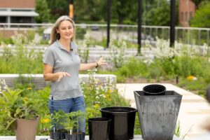 Natalie Bumgarner on a rooftop garden demonstrating how to care for container plants