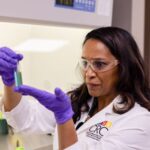 Nicole Labbe holding a test tube in a lab