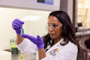 Nicole Labbe holding a test tube in a lab