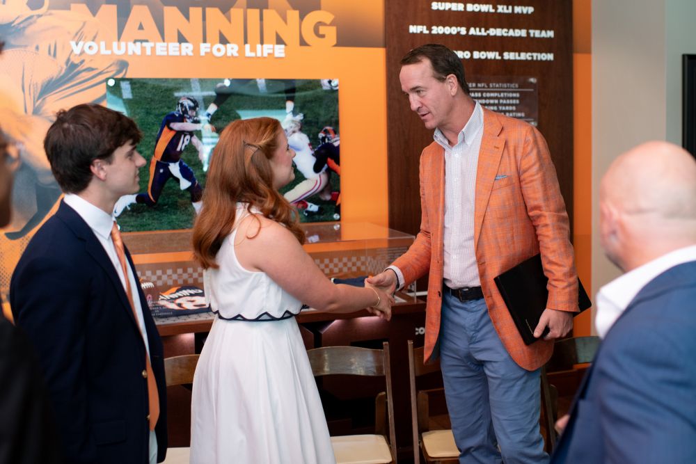 Caroline Garrell shaking Peyton Manning's hand