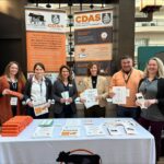 Ansley Roper, Tori Embry, Melissa Huggett, Brittany Whitmire, David Bilderback and Liz Eckelkamp at a dairy display at a conference