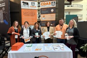 Ansley Roper, Tori Embry, Melissa Huggett, Brittany Whitmire, David Bilderback and Liz Eckelkamp at a dairy display at a conference