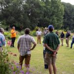 A crowd listening to a speak in the UT Gardens, Knoxville, at the 2025 Green Industry Field Day