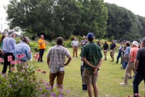 A crowd listening to a speak in the UT Gardens, Knoxville, at the 2025 Green Industry Field Day