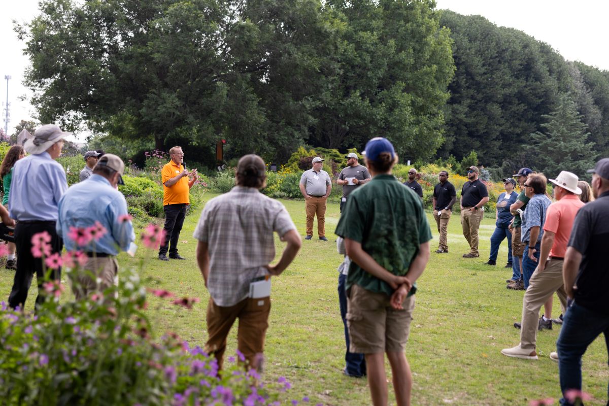 A crowd listening to a speak in the UT Gardens, Knoxville, at the 2025 Green Industry Field Day