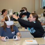 Teachers try virtual reality head sets in a training session
